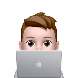 Person peeking from behind a laptop